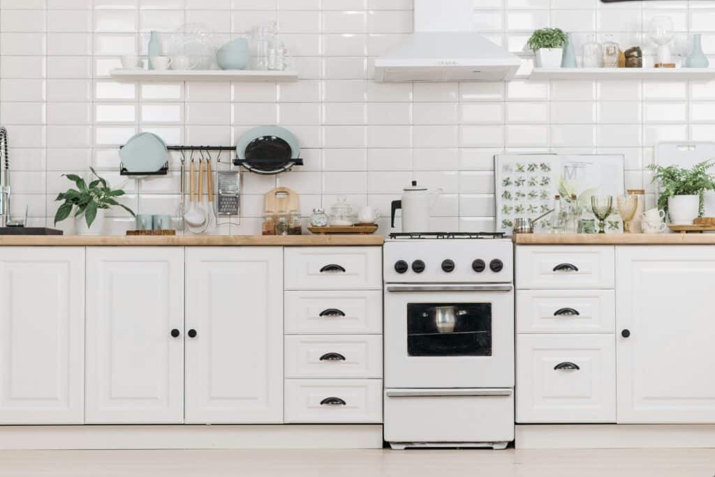 White wooden custom cabinets featuring elegant kitchen handles